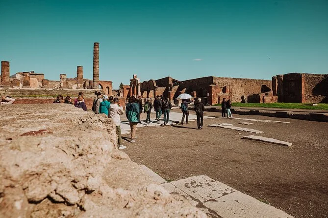 Small group touring the Forum of Pompeii with a guide