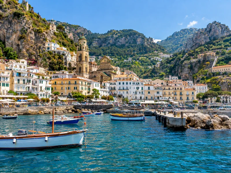 Amalfi town and cathedral bell tower seen from a boat