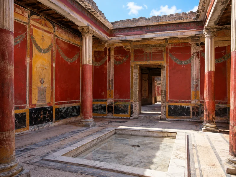 Red and ochre painted walls in a Pompeii villa atrium
